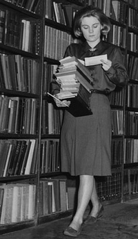 Vintage photo of woman examining books