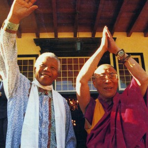 Nelson Mandela waving next to the Dalai Lama