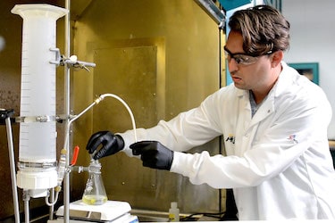 An online chemical engineering degree graduate in the lab