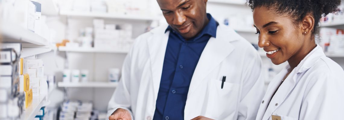 Shot of two pharmacists doing inventory in a pharmacy with a digital tablet