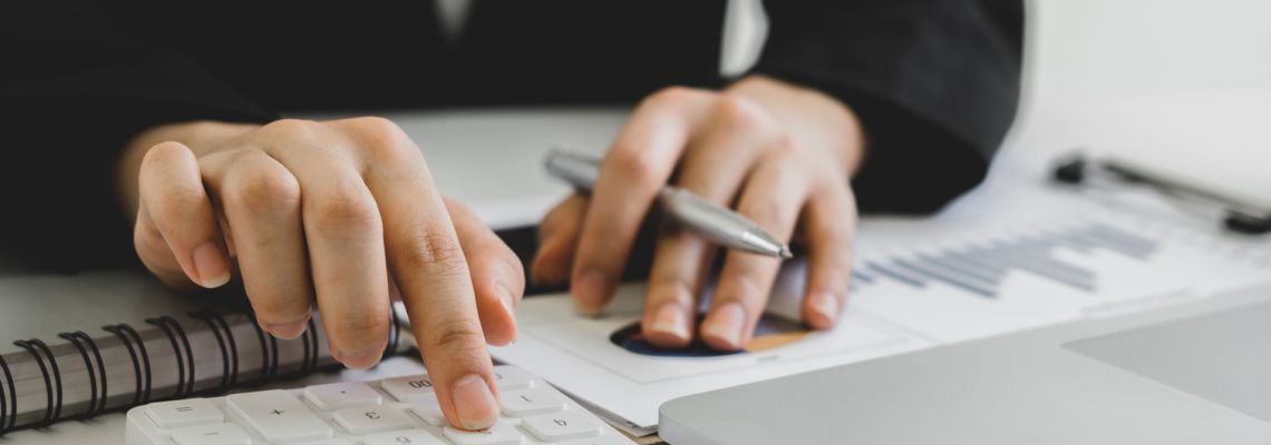accountant or banker calculating or checking balance. Bookkeeper or financial inspector making financial report. Home finances, investment, economy, saving money or insurance concept Bookkeeping, accounting, and auditing clerk uses a calculator.