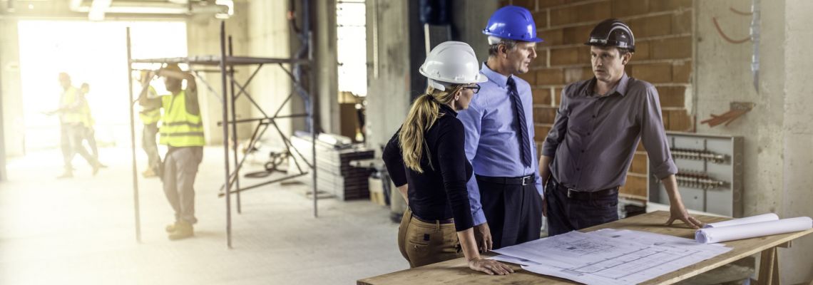 Careers in construction management might involve talking to architects at construction site Careers in construction management might involve talking to architects at construction site