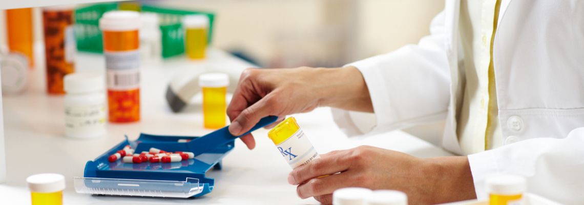 A pharmacy technician sorts pills.