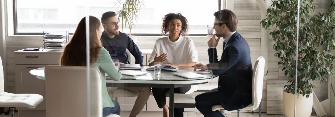 Four people in human resources in a meeting at a table.