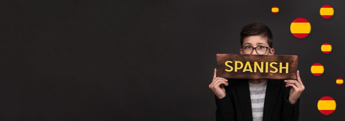 how to become a Spanish teacher, learning Spanish. banner on a black background. a handsome teenager holds an advertising sign. space for copying. how to become a Spanish teacher