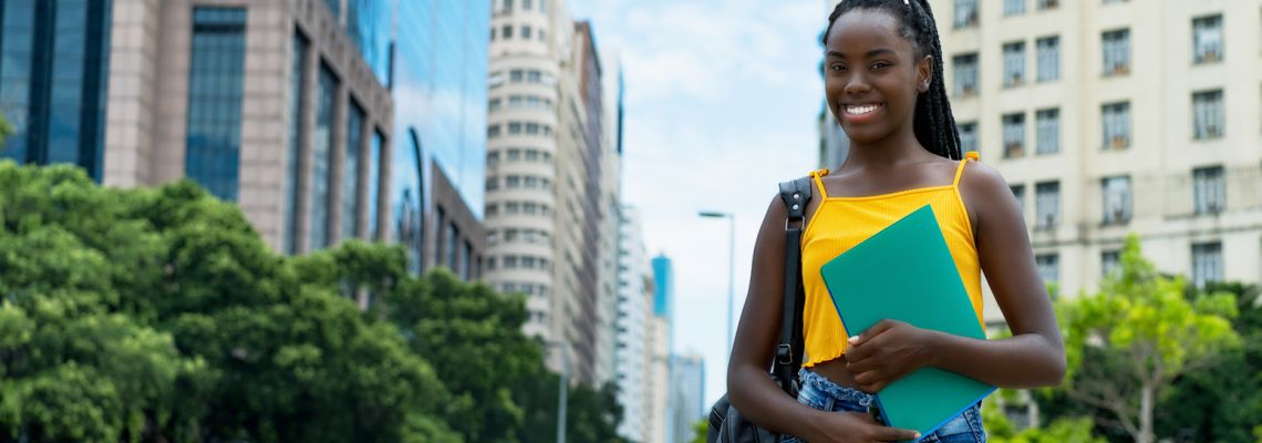 Pretty afro american female student with braids and backpack has online college scholarships online college scholarships