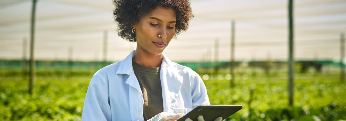 Careers in Sustainability, Shot young scientist using a digital tablet while working with crops on a farm Careers in Sustainability