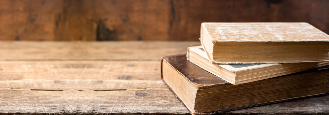 Religious Studies Jobs, Old books on wooden shelf. Education learning concept with old book in library. Copy space Religious Studies Jobs