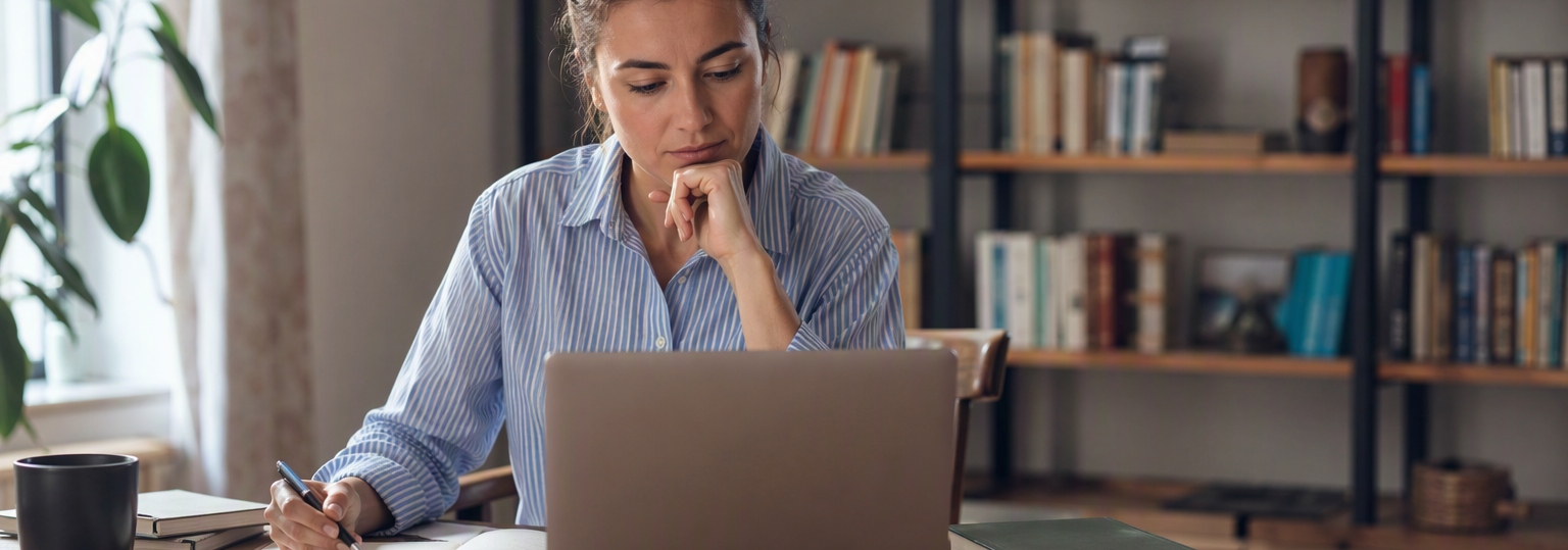Two adults discussing options for online English master's programs in a study setting