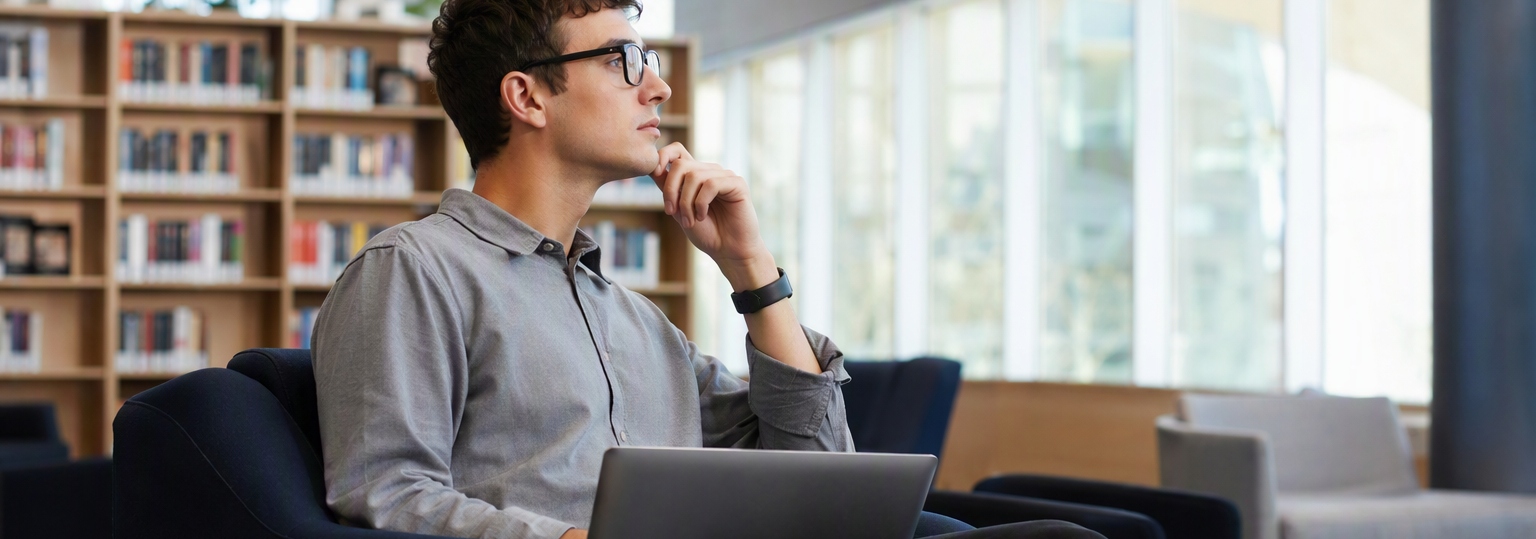 A professional adult researching cybersecurity career options in a modern workspace