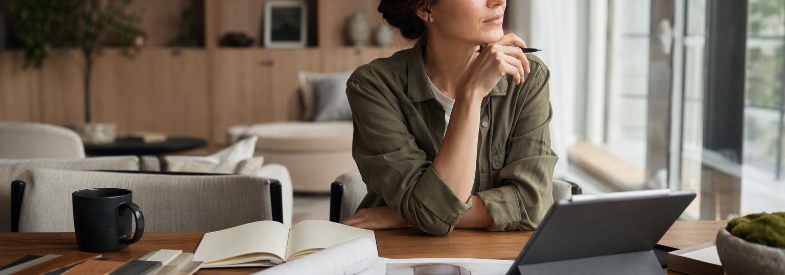 Adult student researching online English degree options in a bright, modern study environment